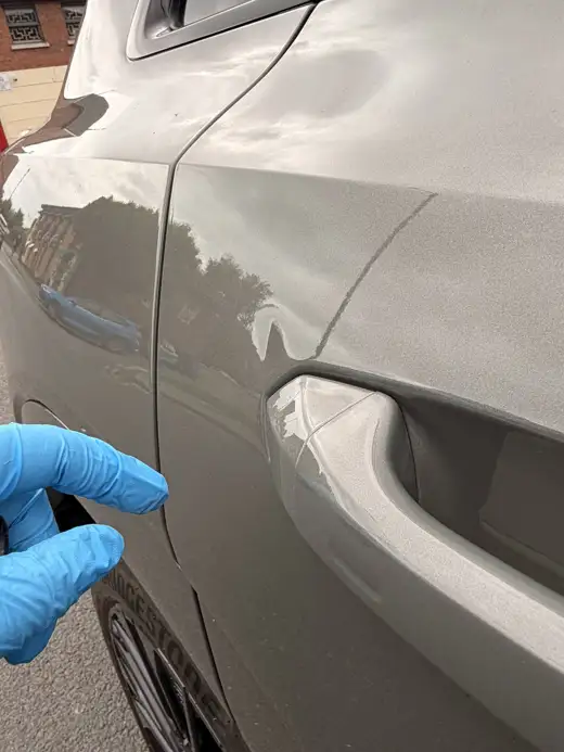 Small dent noted on a door, 2024 Audi Q8 e-tron